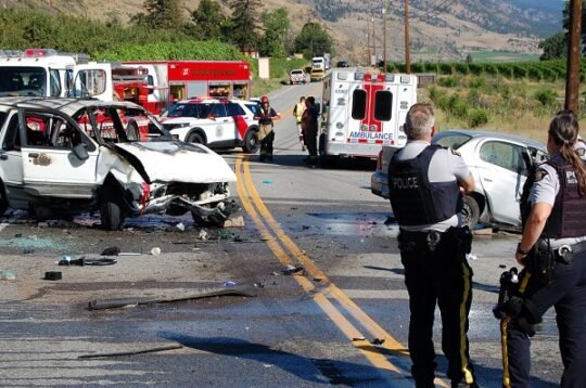 https://www.squamishreporter.com/wp-content/uploads/2025/08/RCMP-officers-look-over-a-wrecked-white-Ford-Explorer-and-emergency-vehicles-on-Highway-97-near-Oliver-540x358.jpg