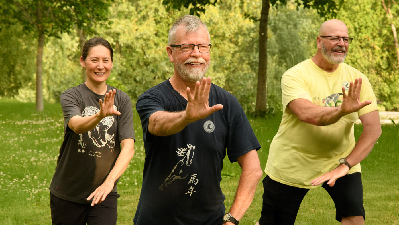 Three people doing tai chi in Squamish.
