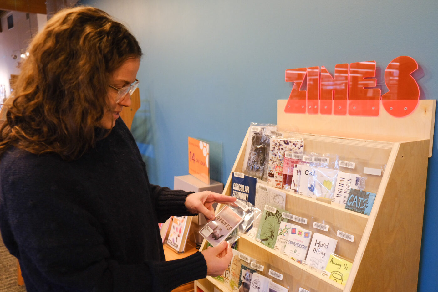 Rachel Bergquist, Squamish Library's programming coordinator, shows off the library's permanent zine stand.