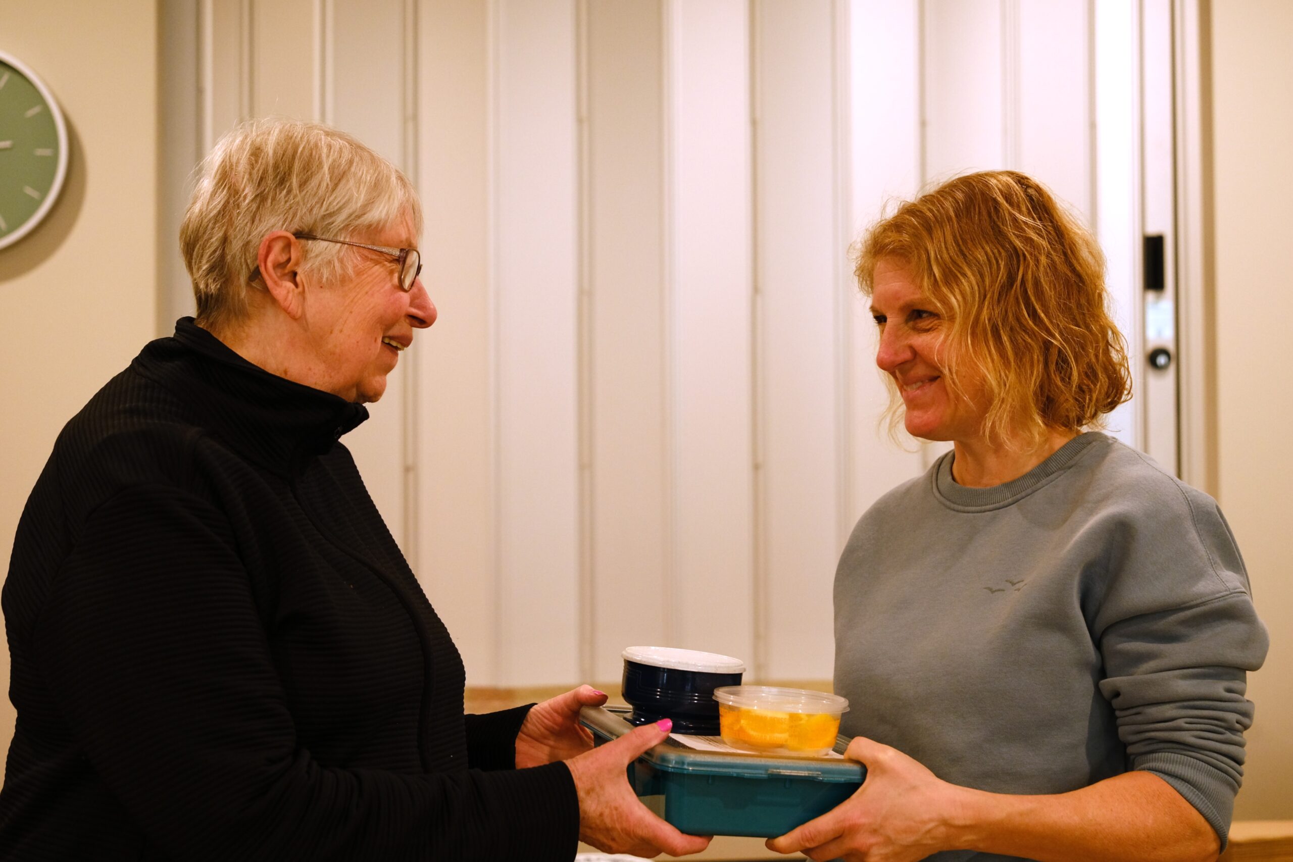 Margo Wyssen, left, receives a Meals on Wheels delivery from Nicole Saugstad at Westwinds in Squamish. The program, run by Squamish Helping Hands, provides $5 meals to seniors twice a week.